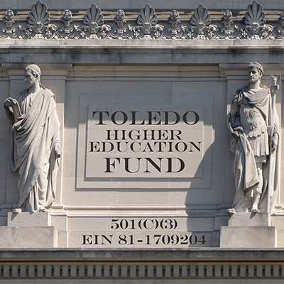 A marble facade of Roman scholars support the Toledo Washington Higher Education Fund. Illustration by Morgan Online Media.